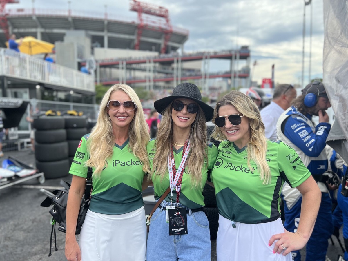 Hannah with two colleagues in team kit in the pit at the Nashville Grand Prix